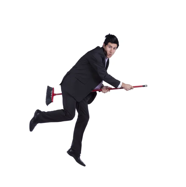Businessman flying a broom — Stock Photo, Image