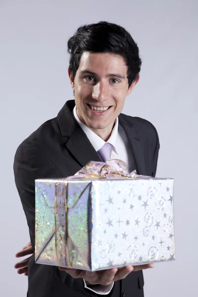 Businessman with a gift package — Stock Photo, Image