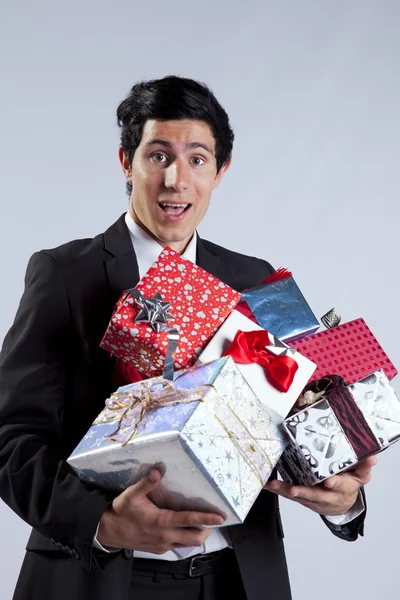 Uomo d'affari con molti pacchetti regalo — Foto Stock