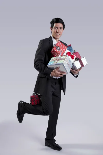 Businessman with many gift packages — Stock Photo, Image