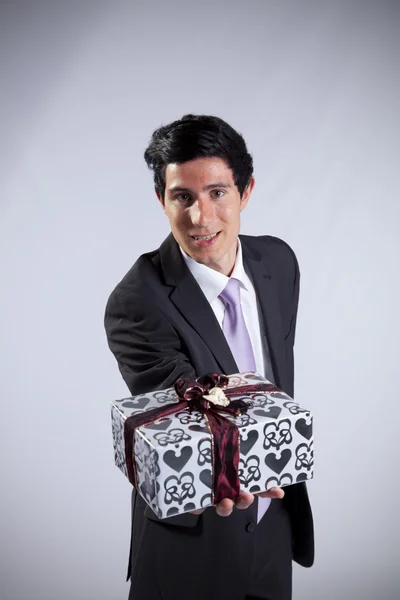 Businessman with a gift package — Stock Photo, Image