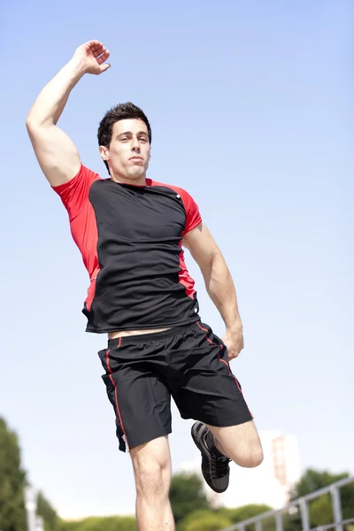 Спортсмен стрибає в парку — стокове фото