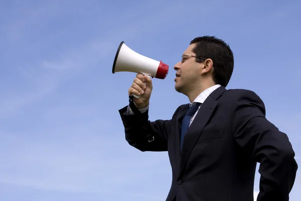 Businessman speaking with a megaphone — Stock Photo, Image