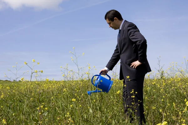 Businessman with a flowerpot — Stock Photo, Image