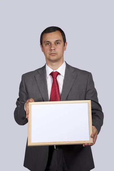 Uomo d'affari con una lavagna bianca — Foto Stock