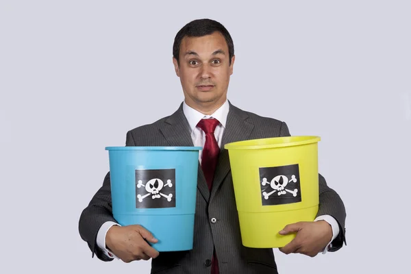 Businessman holding dangerouse buckets — Stock Photo, Image