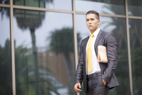 Businessman walking next to his office — Stock Photo, Image