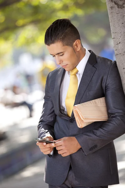 Businessman sending messages at the cellular — Stock Photo, Image