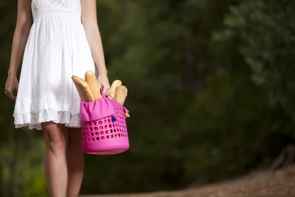 Kobieta w lesie z chleba w koszyku — Zdjęcie stockowe
