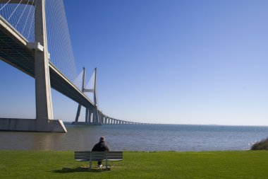 Lonely senior by the bridge clipart