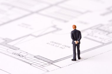 Businessman examining a blueprint clipart