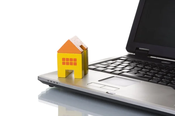 House toy over a laptop — Stock Photo, Image