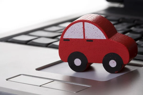 Toy car on a laptop — Stok fotoğraf