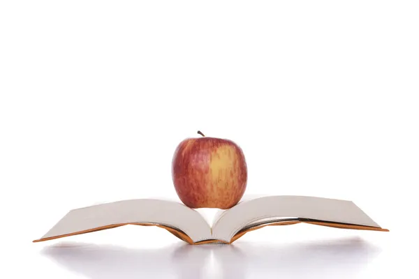 Apple in the book — Stockfoto