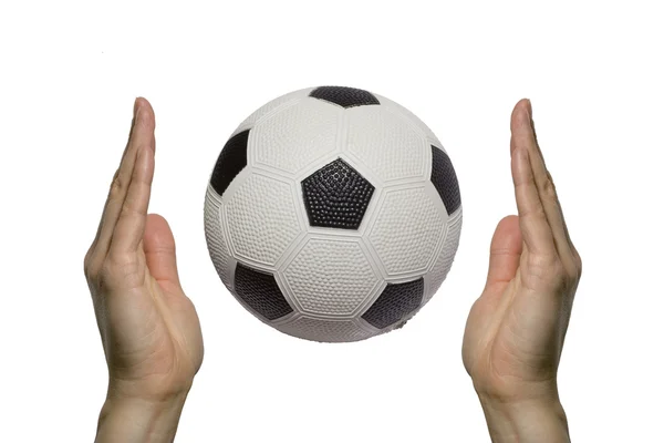 Soccer ball between two hands — Stock Photo, Image