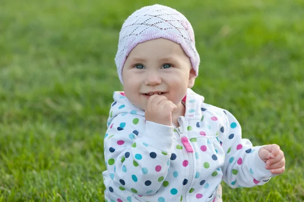 Smiling little girl in the polka dot jacket — Stock Photo, Image