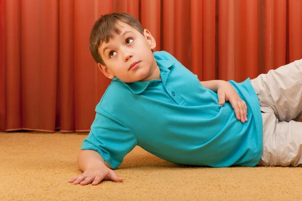 Thoughtful boy on the floor — Stock Photo, Image