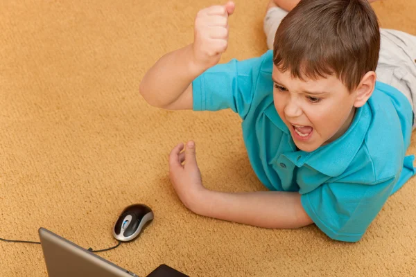 Expressive boy with a laptop — Stock Photo, Image