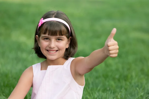 Happy girl holding thumb up — Stock Photo, Image