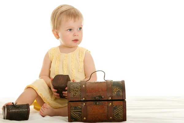 Little girl playing wooden chests — Stock Photo, Image