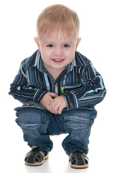 Smiling toddler sits down — Stock Photo, Image