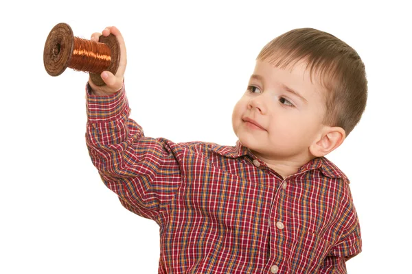 Cheerful little kid holding a roll of cooper wire — Stock Photo, Image