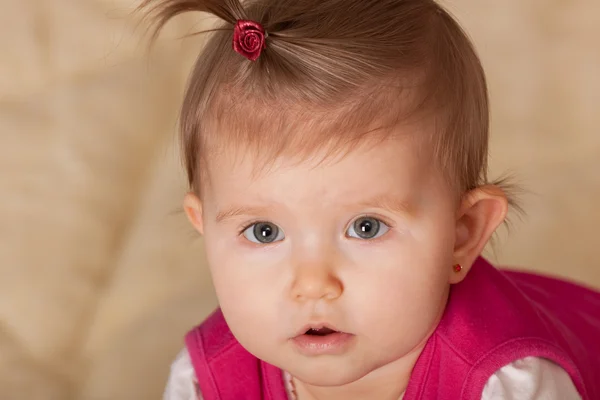 Portrait of a cute toddler with a tail on her forehead — Stock Photo, Image