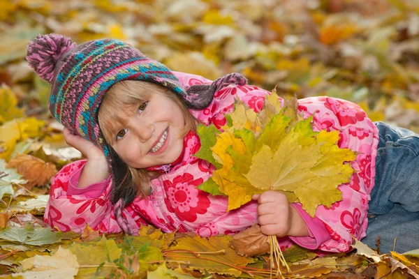 Pretty little girl with yellow leaves — Stock Photo, Image