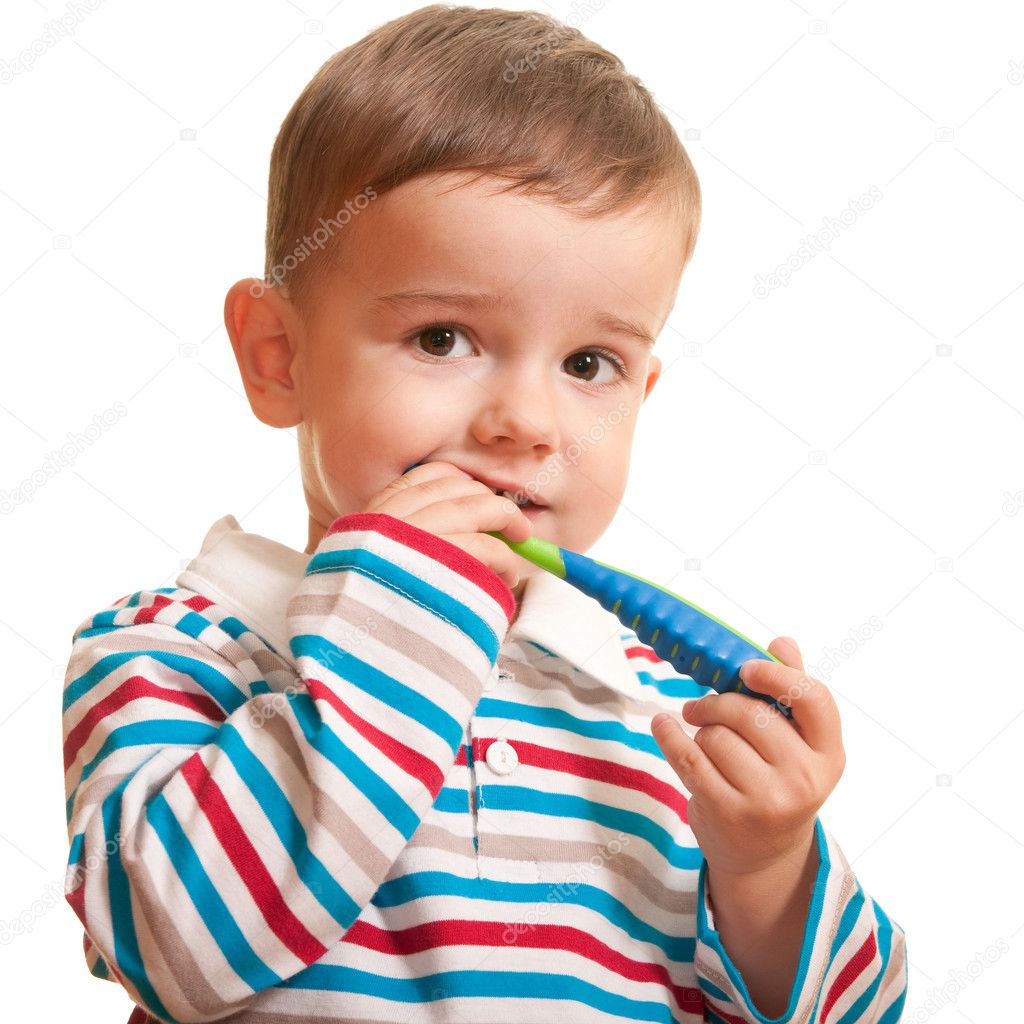 Little boy discovering teeth brushing