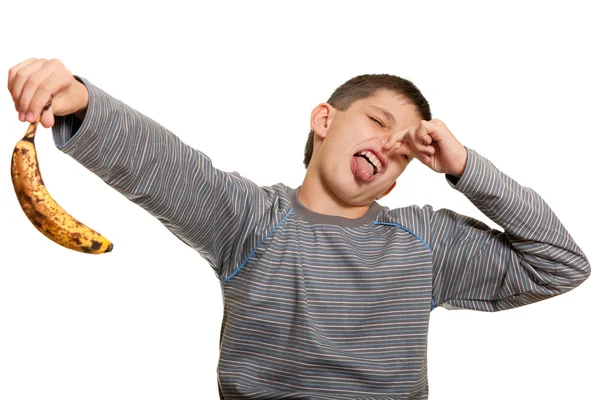 Dissatisfied kid holding an ugly banana — Stock Photo, Image
