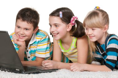 Three cheerful kids are using a laptop clipart