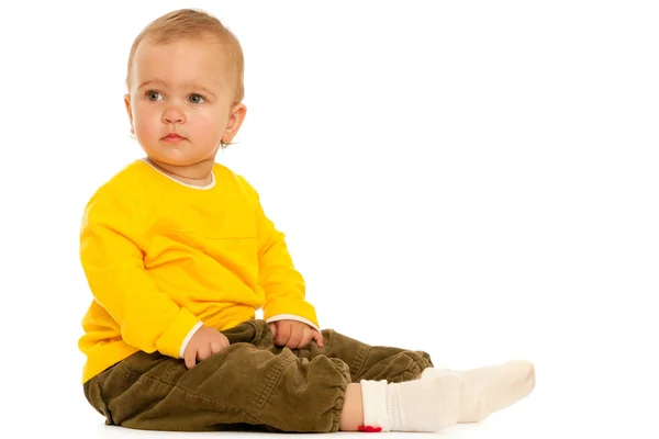 Fundersam småbarn i gult — Stockfoto