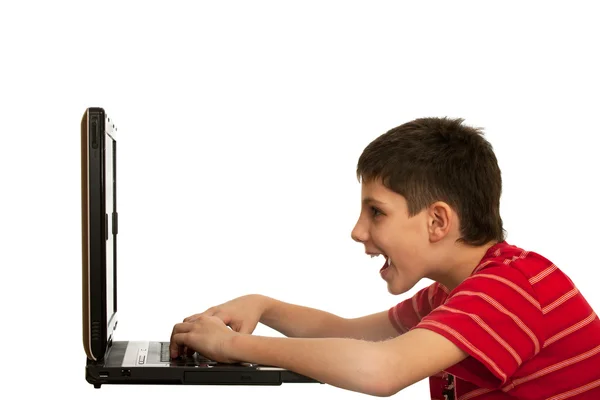 Kid is playing computer game on the laptop — Stock Photo, Image