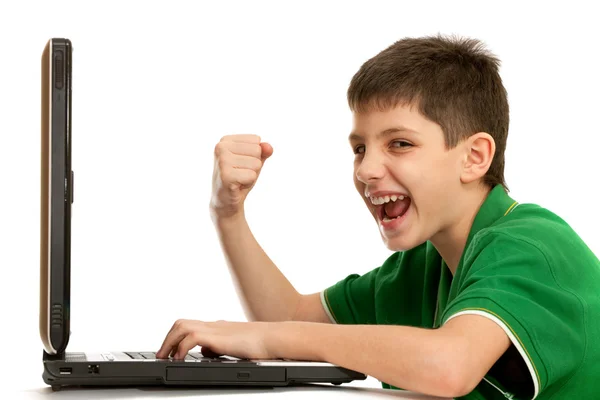 Emocional niño está jugando juego de ordenador en el portátil —  Fotos de Stock