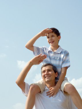 Father and his son play outdoor clipart