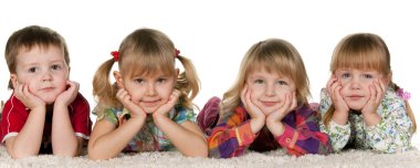 Four children lying on the carpet clipart