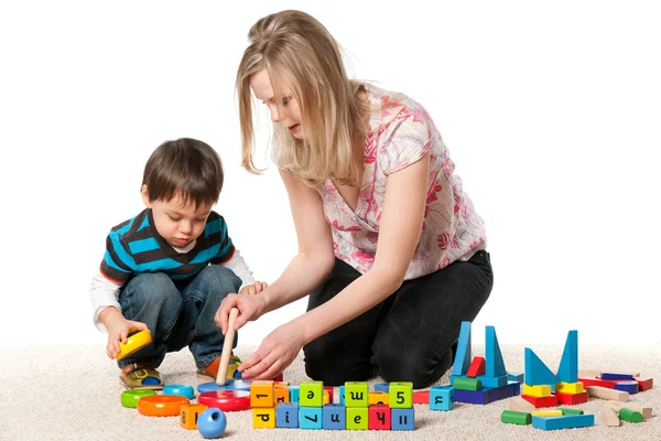 Mother and son playing on the carpet — Stock Photo, Image