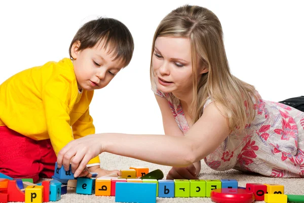 Mother and son are playing on the carpet — Stock Photo, Image
