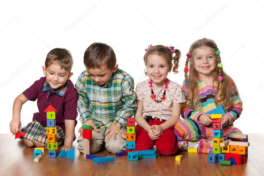 Four children are playing on the floor