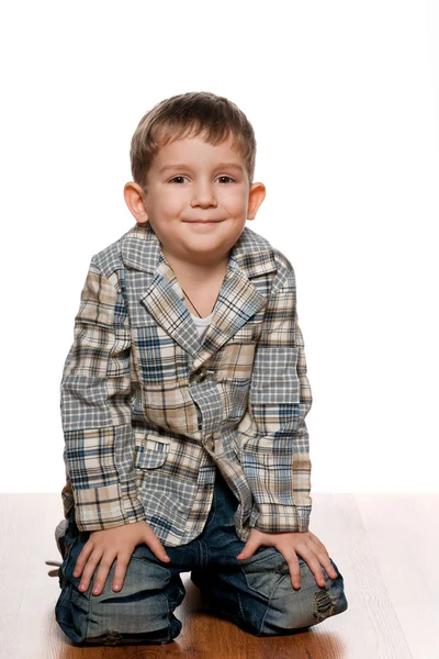 Cute little boy on the wooden floor — Stock Photo, Image