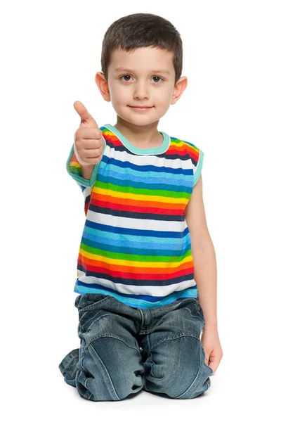 Cute little boy holding thumb up — Stock Photo, Image