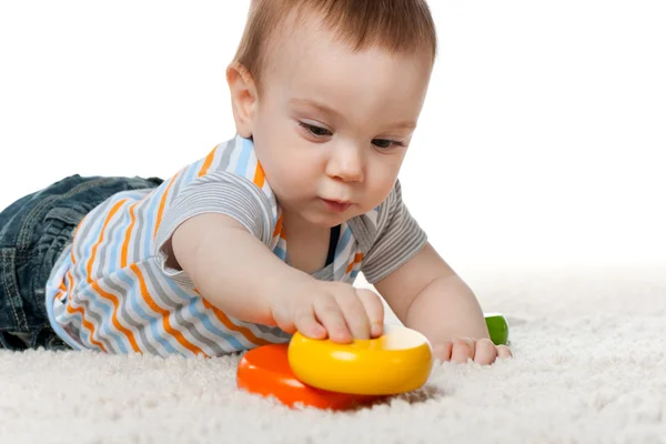 Pensive baby boy with toys — Stock Photo, Image