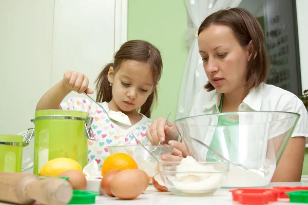 Sisters makeing cake in the kitchen — Stock Photo, Image