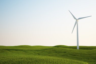 Wind turbine on green grass field clipart