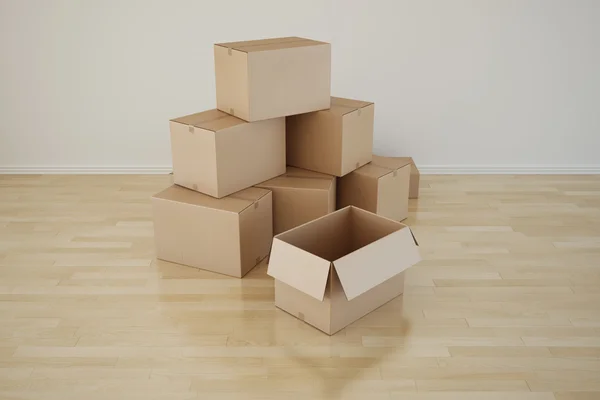 Cardboard boxes in empty room — Stock Photo, Image