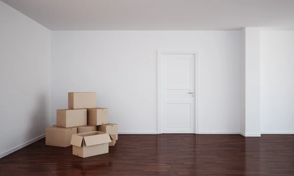 Habitación vacía con cajas de cartón y suelo oscuro —  Fotos de Stock