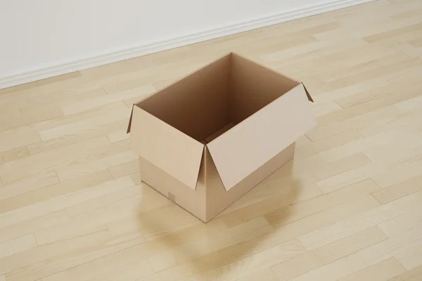 Κουτί από χαρτόνι σε άδειο δωμάτιο — Φωτογραφία Αρχείου