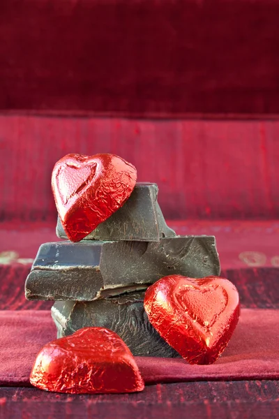 stock image Candy Hearts on a Pile of Dark Chocolate Pieces