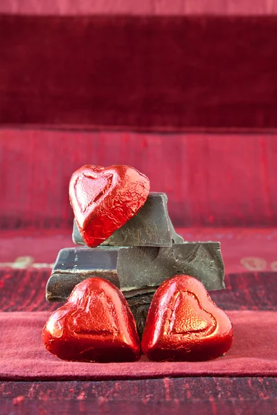 stock image Candy Hearts on a Pile of Dark Chocolate Pieces