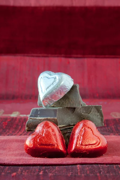 stock image Candy Hearts on a Pile of Dark Chocolate Pieces